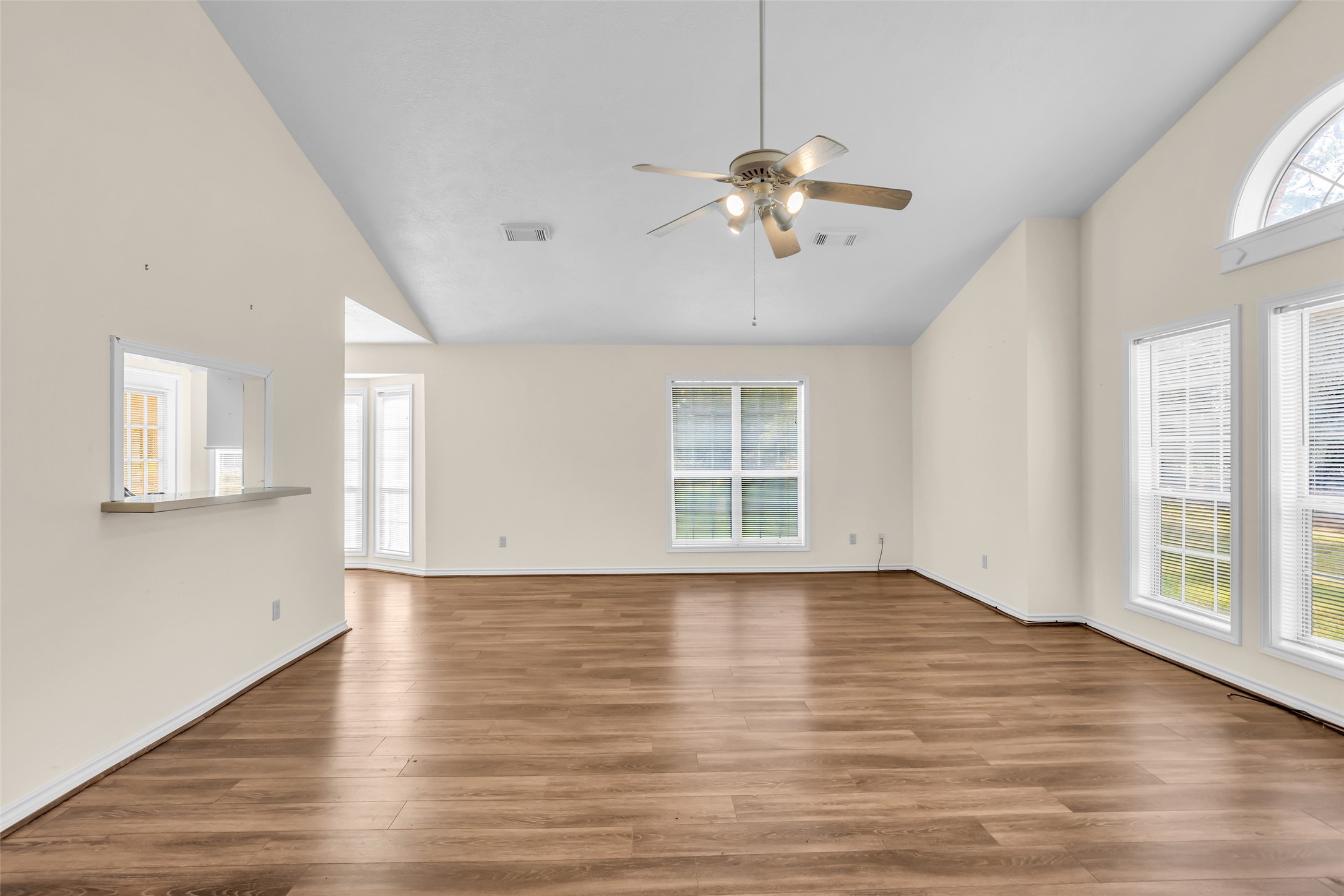 7 Lazy Spring Trinity, TX 75862 - Photo 4 of 25 Bright, open-concept living and dining area featuring durable wood-look flooring and a fresh, neutral paint palette.