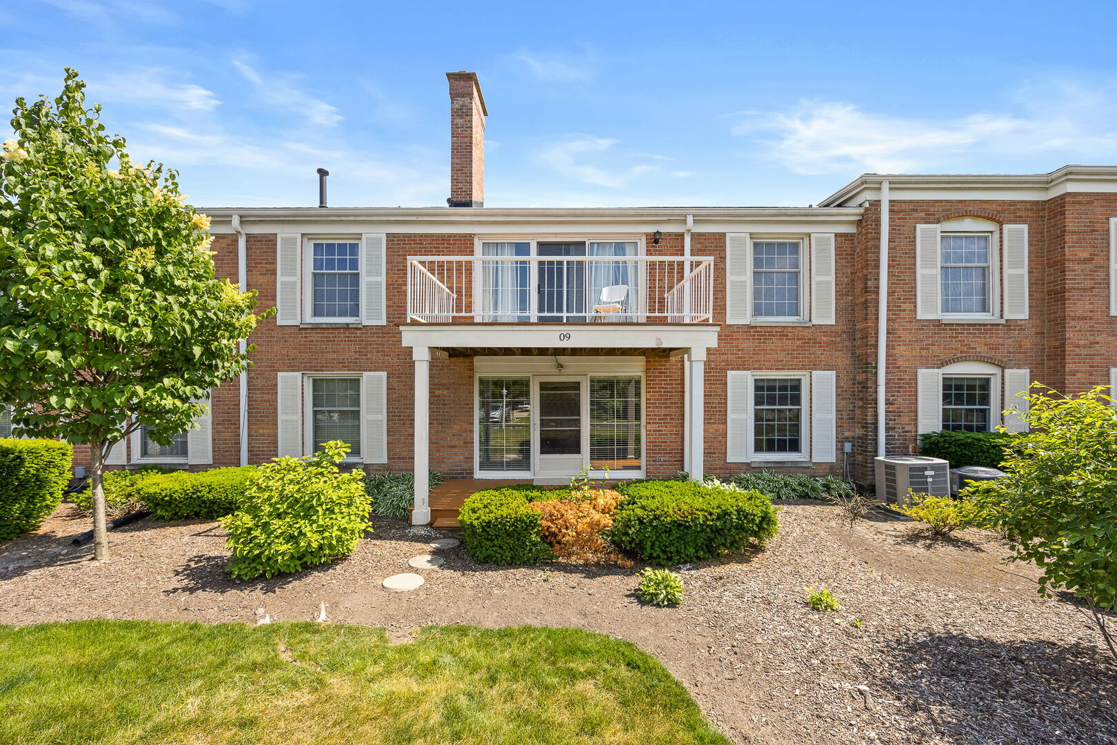 124 Carriage Way Drive, Unit B109 Burr Ridge, IL 60527 - Photo 26 of 31 a front view of a house with garden