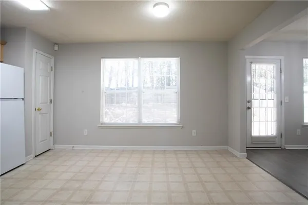 an empty room with wooden floor and fireplace
