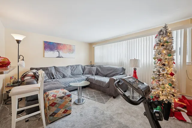 a living room with furniture a flowers and a window