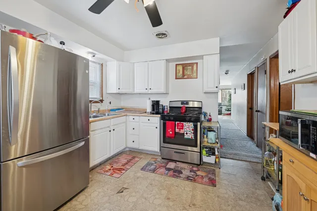 a kitchen with stainless steel appliances a refrigerator sink and cabinets