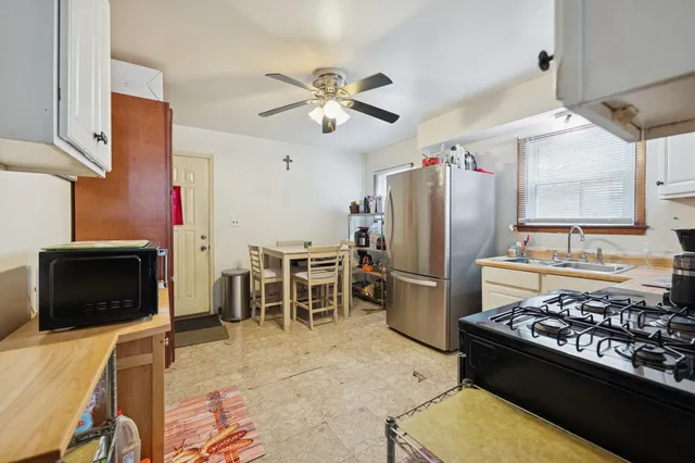 a kitchen with stainless steel appliances granite countertop a stove refrigerator and microwave