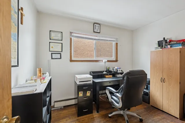 a view of a workspace with furniture and a window