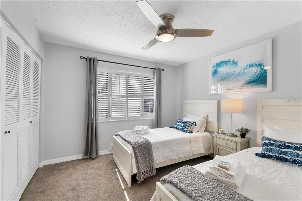 1640 Stickney Point Road, Unit 40101 Sarasota, FL 34231 - Photo 12 of 27 a bedroom with two beds and painting on the wall