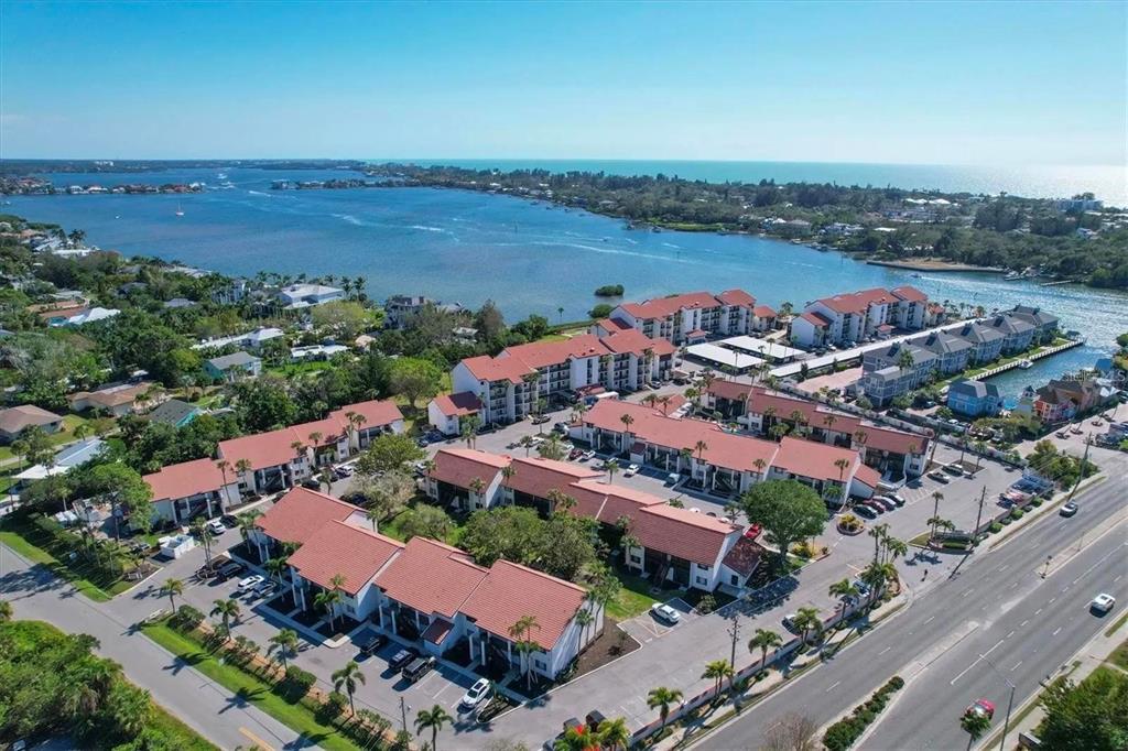 1640 Stickney Point Road, Unit 40101 Sarasota, FL 34231 - Photo 26 of 30 an aerial view of a city with lots of residential buildings and ocean view
