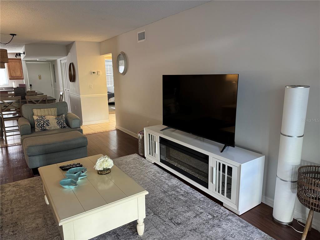 1640 Stickney Point Road, Unit 40101 Sarasota, FL 34231 - Photo 3 of 30 a living room with furniture and a flat screen tv