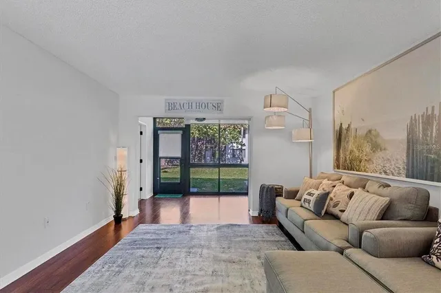 a living room with furniture and a floor to ceiling window