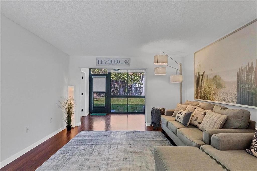 1640 Stickney Point Road, Unit 40101 Sarasota, FL 34231 - Photo 5 of 30 a living room with furniture and a floor to ceiling window