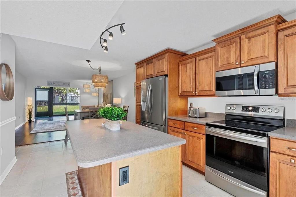 1640 Stickney Point Road, Unit 40101 Sarasota, FL 34231 - Photo 5 of 27 a kitchen with stainless steel appliances a stove microwave and refrigerator