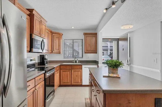 a kitchen with stainless steel appliances a sink a stove and a refrigerator