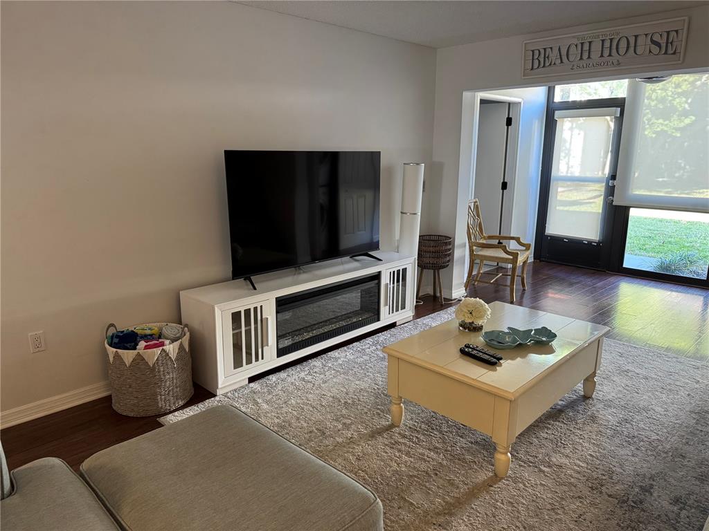 1640 Stickney Point Road, Unit 40101 Sarasota, FL 34231 - Photo 7 of 30 a living room with furniture and a flat screen tv