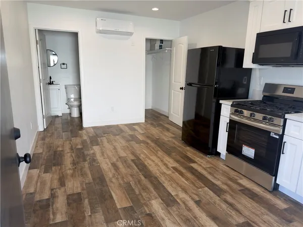a kitchen with a refrigerator stove and microwave