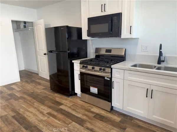 a kitchen with a stove and a refrigerator