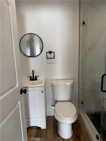 a bathroom with a toilet and a mirror