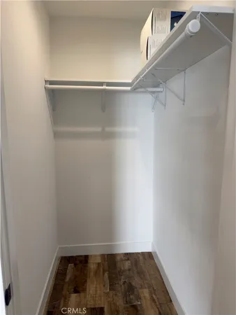 a view of walk in closet with empty racks