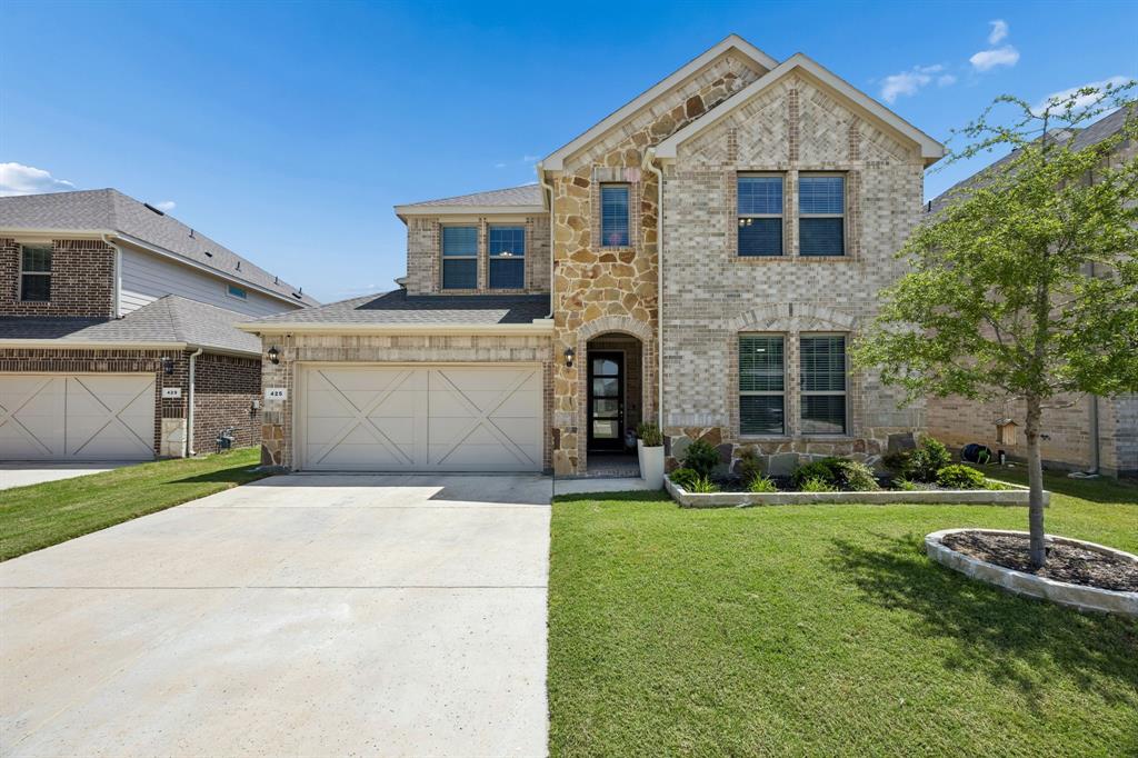 425 Breeds Hl Road Little Elm, TX 75068 - Photo 1 of 38 a front view of a house with a yard and garage