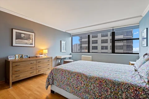 a bedroom with a large bed and a window