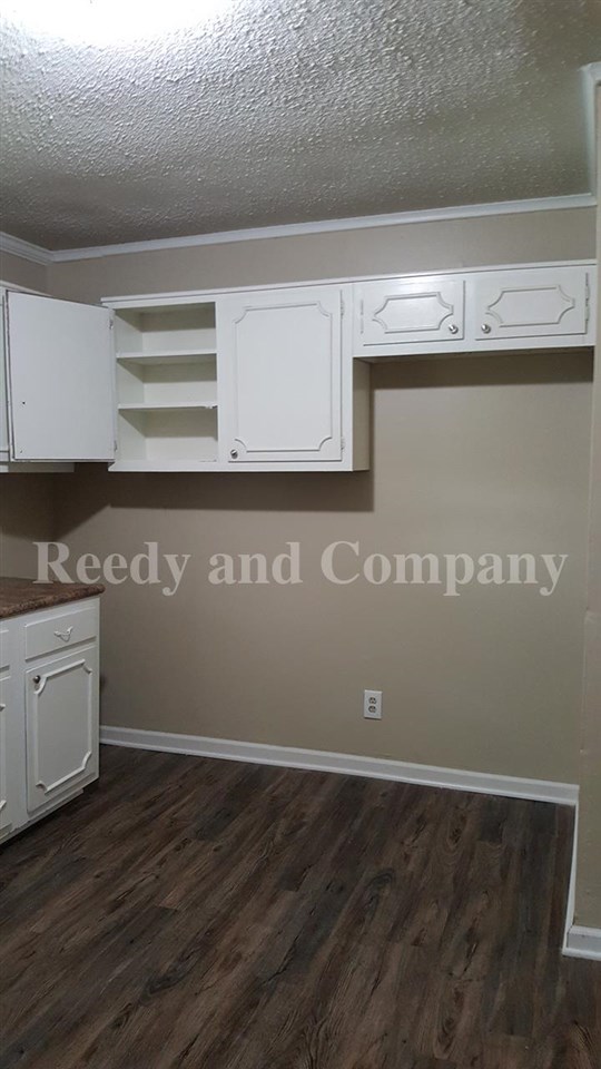 3947 McCain Road Memphis, TN 38109 - Photo 13 of 17 a view of a kitchen with granite countertop cabinets and a wooden floor