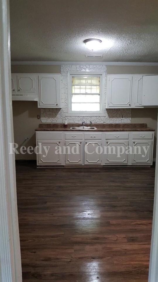3947 McCain Road Memphis, TN 38109 - Photo 17 of 17 a kitchen with stainless steel appliances granite countertop a sink a stove and a wooden floors