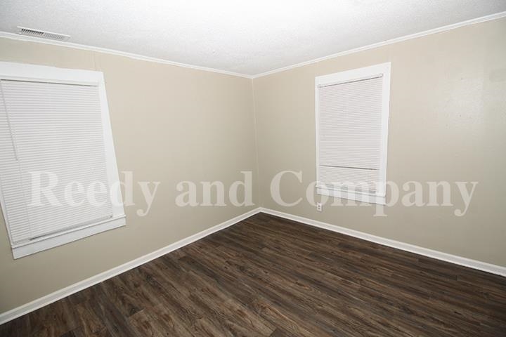 3947 McCain Road Memphis, TN 38109 - Photo 8 of 17 a view of an empty room with wooden floor and a window