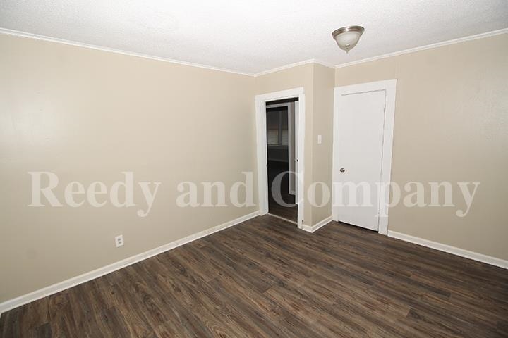 3947 McCain Road Memphis, TN 38109 - Photo 9 of 17 an empty room with wooden floor and windows