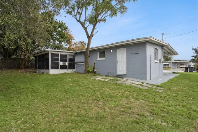 a front view of house with yard and trees