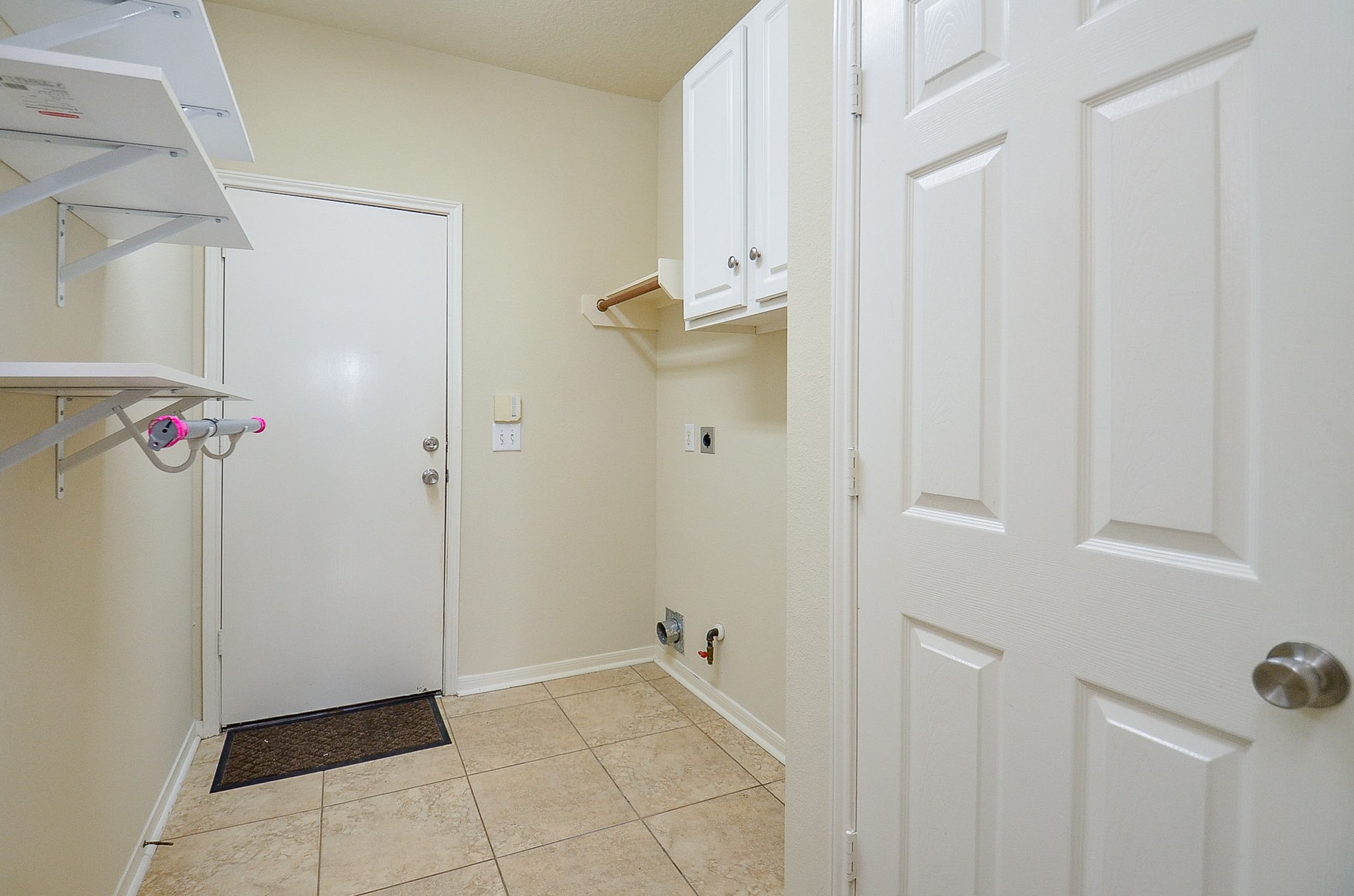 1222 Ragsdale Lane Katy, TX 77494 - Photo 28 of 31 The utility rom has options for a gas or electric dryer. Hanging space and storage cabinet.