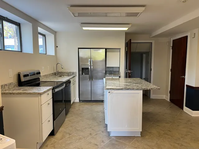 a kitchen with a sink stove and refrigerator