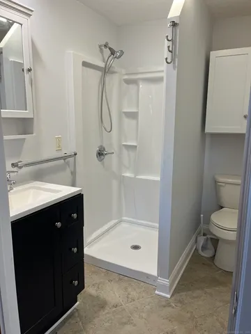 a bathroom with a sink toilet and shower