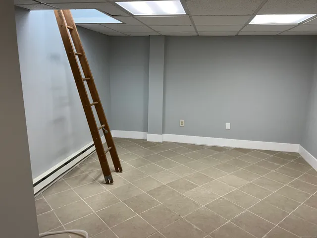 a view of a room with rack and white walls