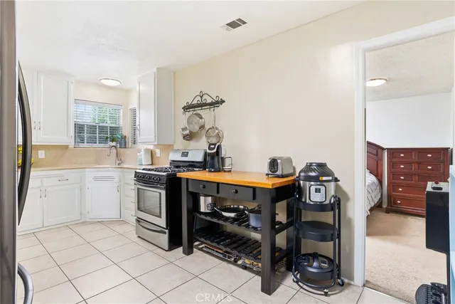 a kitchen with a sink appliances and cabinets