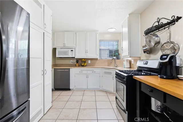 a kitchen with a stove a refrigerator and a sink