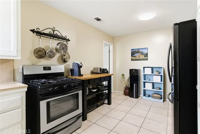 a kitchen with stainless steel appliances granite countertop a stove and a refrigerator