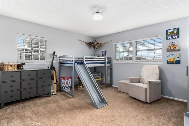 a bedroom with furniture and a window