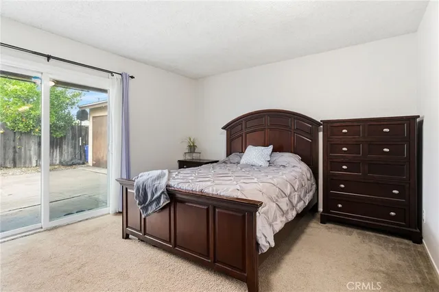 a bedroom with a bed and a large window