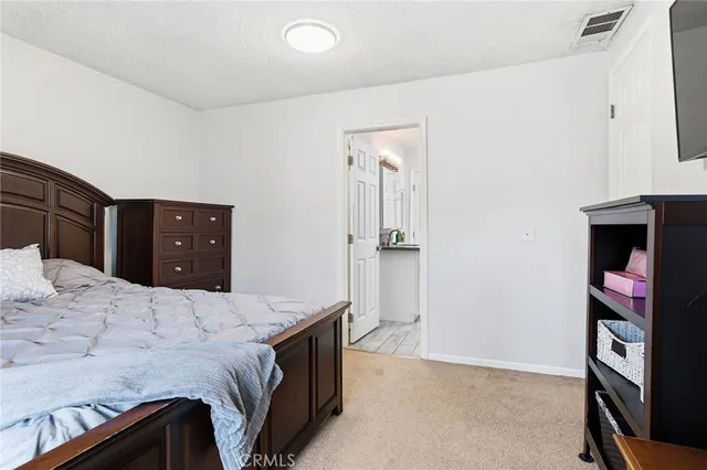 a bedroom with a bed and a dresser