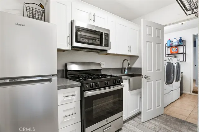 a kitchen with stainless steel appliances granite countertop a stove and a refrigerator