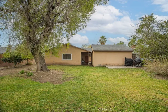 a view of a backyard with large trees