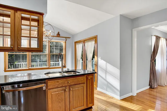a view of a big room with wooden floor and door