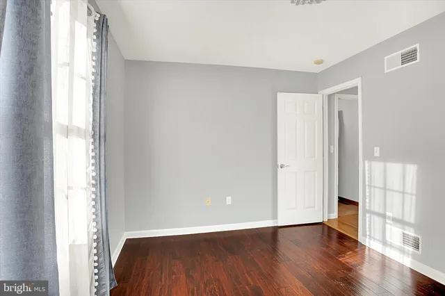 a bathroom with a toilet a sink a mirror and shower