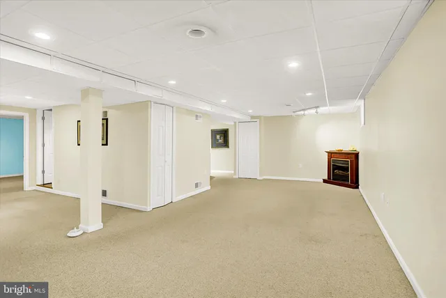 a view of a house with a yard and a large tree