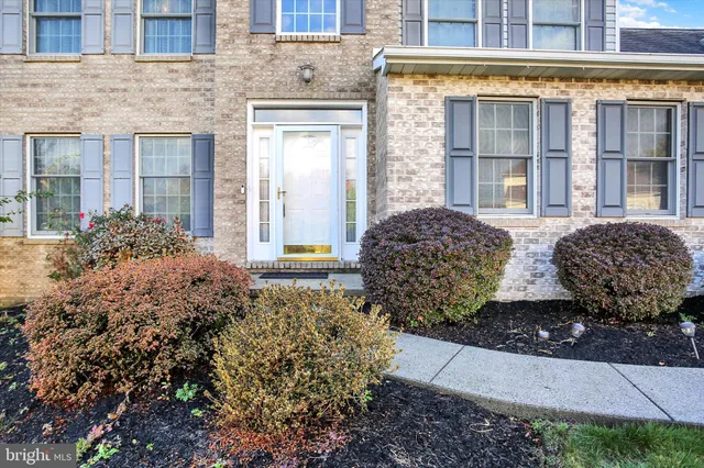 a view of a door of a house with a backyard