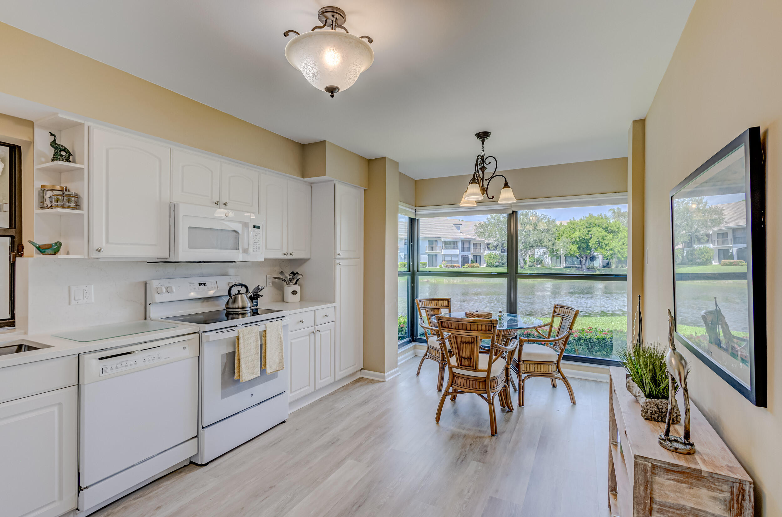 16623 Traders Crossing North, Unit 131 Jupiter, FL 33477 - Photo 13 of 42 a view of a dining room with furniture window and wooden floor