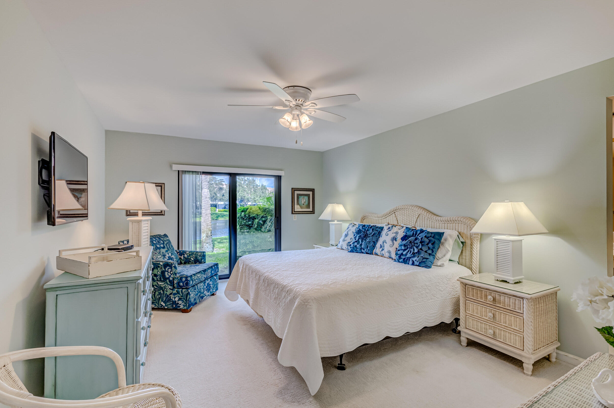 16623 Traders Crossing North, Unit 131 Jupiter, FL 33477 - Photo 23 of 42 a bed room with a bed and a chandelier