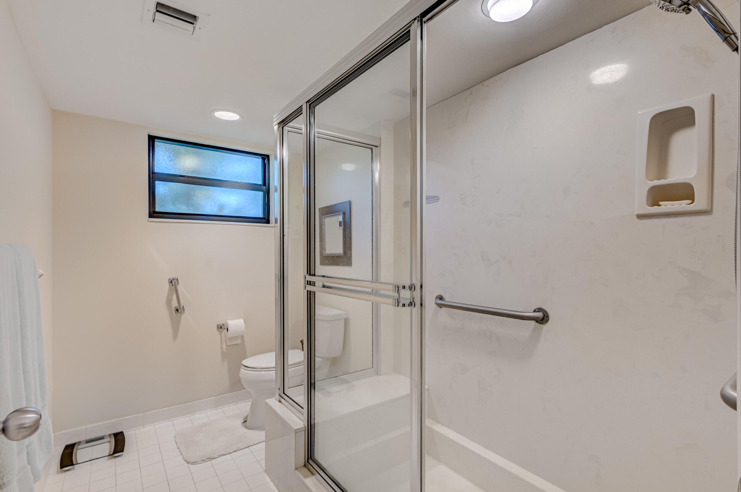 16623 Traders Crossing North, Unit 131 Jupiter, FL 33477 - Photo 28 of 42 a bathroom with a shower and a toilet