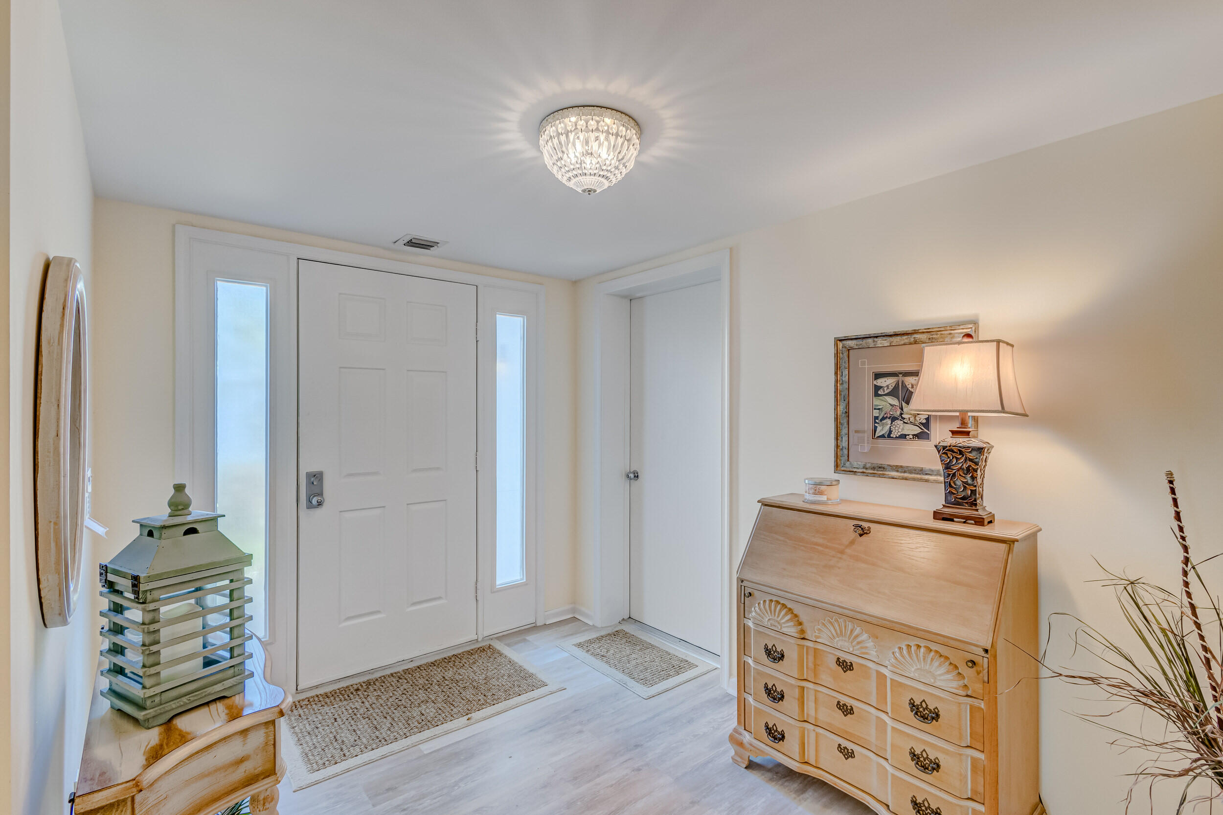 16623 Traders Crossing North, Unit 131 Jupiter, FL 33477 - Photo 3 of 42 a view of a hallway with closet and wooden floor