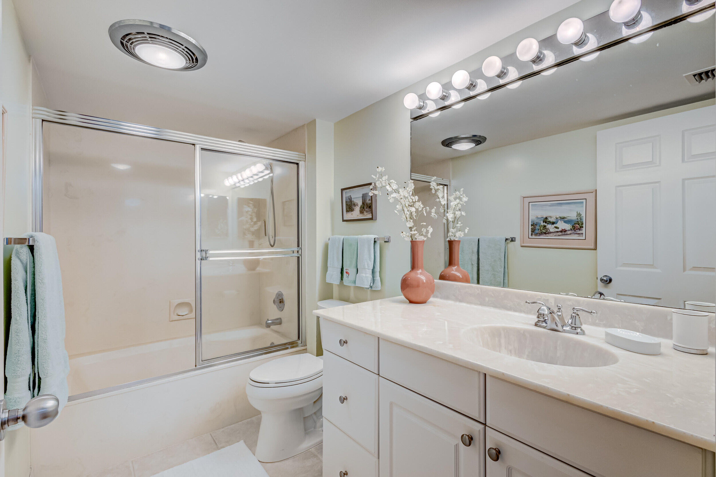 16623 Traders Crossing North, Unit 131 Jupiter, FL 33477 - Photo 31 of 42 a bathroom with a toilet a sink and a large mirror