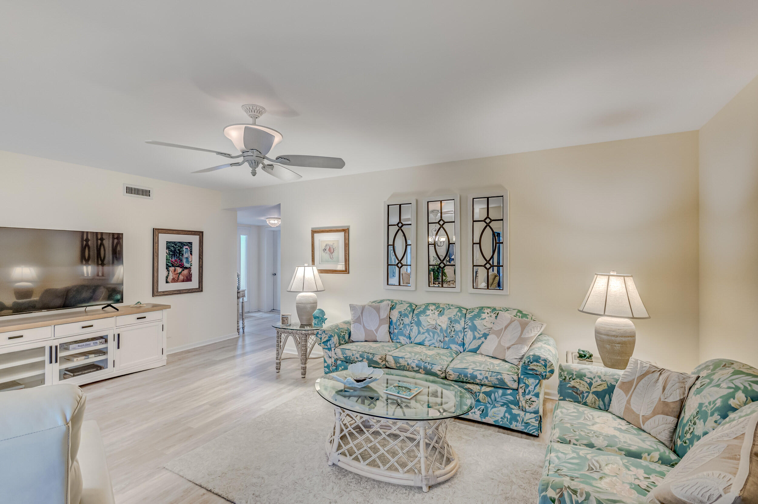 16623 Traders Crossing North, Unit 131 Jupiter, FL 33477 - Photo 4 of 42 a living room with furniture and a flat screen tv