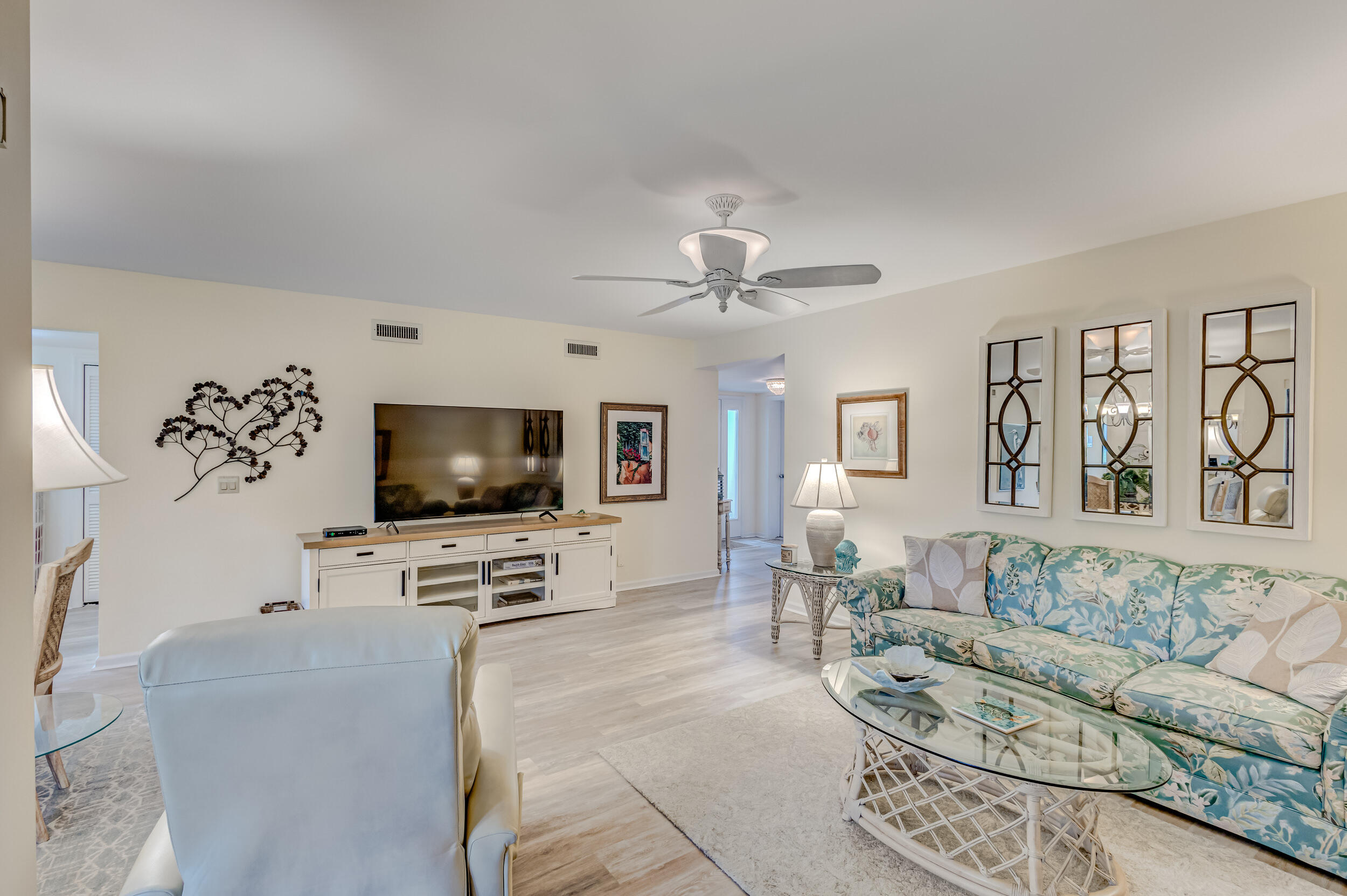 16623 Traders Crossing North, Unit 131 Jupiter, FL 33477 - Photo 5 of 42 a living room with furniture and a flat screen tv