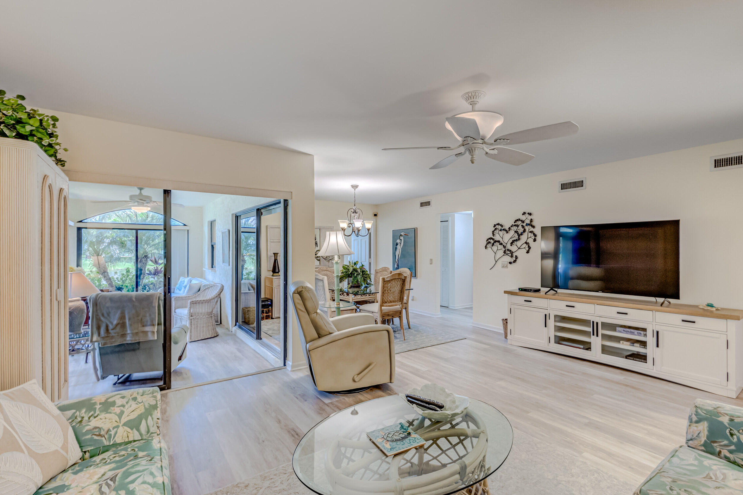 16623 Traders Crossing North, Unit 131 Jupiter, FL 33477 - Photo 7 of 42 a living room with furniture and a flat screen tv